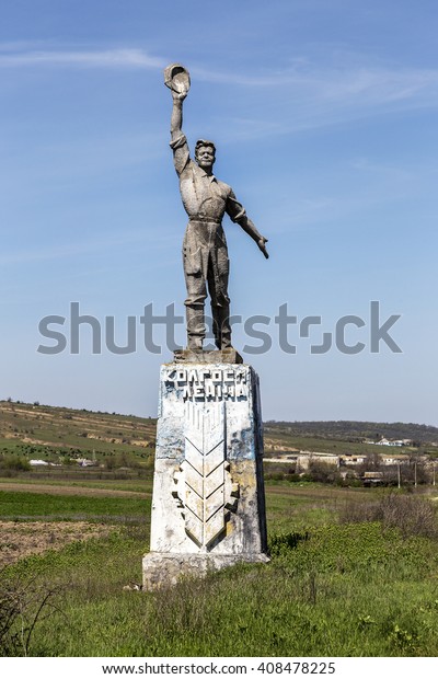 The old Soviet\
sculpture Worker and Collective Farm on road offers entry into a\
dying Ukrainian village. Old Soviet monument, Odessa. Legacy of \
Soviet period in Ukraine.