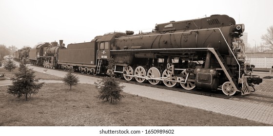 Old Soviet steam locomotive in the museum of railway equipment in sepia tone in vintage style