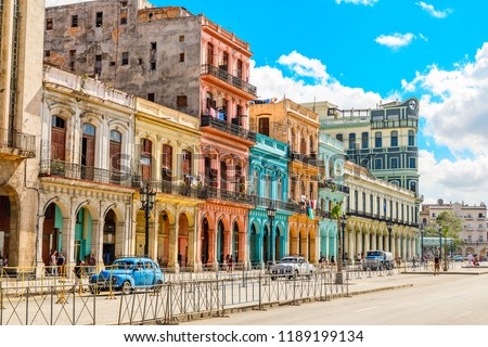 Old Spanish colonial living colorful houses across the road in the center of Havana, Cuba