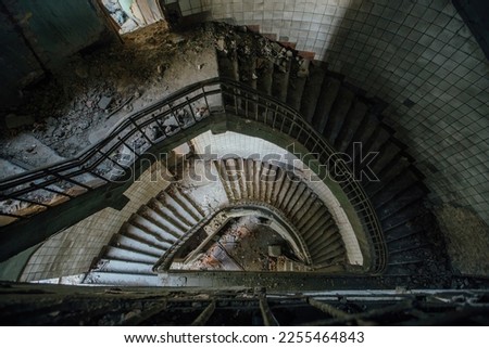 Old spiral staircase at the old abandoned building, top view.