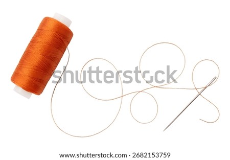 Old spool of thread and needle on a white background. Sewing accessories