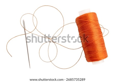 Old spool of thread and needle on a white background. Sewing accessories
