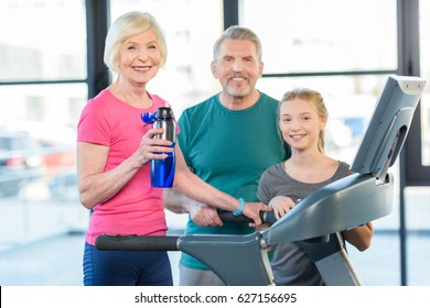 old sport couple and girl training on treadmill in fitness class   - Powered by Shutterstock