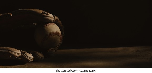 Old Sports Nostalgia Banner Background With Used Baseball Glove And Ball With Copy Space.