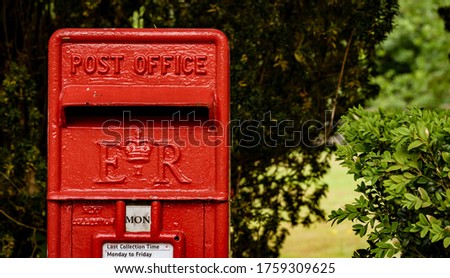 Old square style red post box in UK