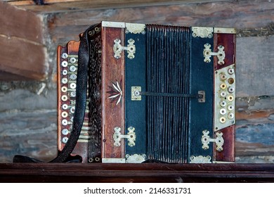 An old squeezebox (also squeeze box, squeeze-box). Musical instrument