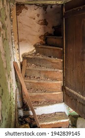 Old staircase in an abandoned home. Natural light. 