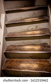 An Old Staircase With Wooden Steps With A Varnish Worn Off From Long Use, Which Covered The Steps, And Recesses In The Surface Of The Steps, Formed From Shuffling Feet