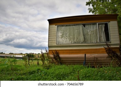 Old Static Caravan On The Field And Clouds