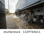 in an old station there is a steam trien waiting for his passengers