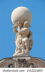 Old statue of powerful Heracles aka Atlas of Renaissance Era holding a globe, Earth at his shoulders in Dresden historical downtown at blue sky background, Germany