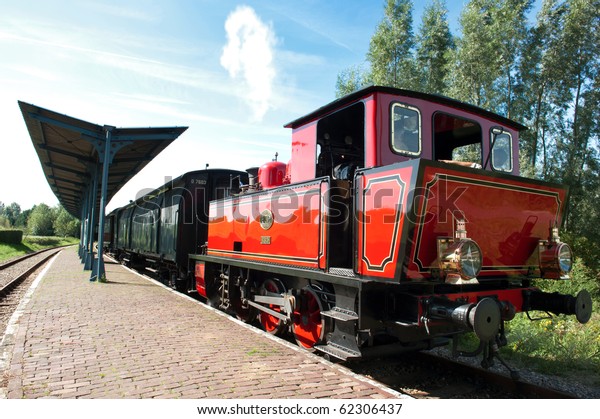 Old steam engine train\
at the station