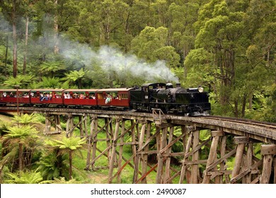 Old Steam Train Crossing A Bridge