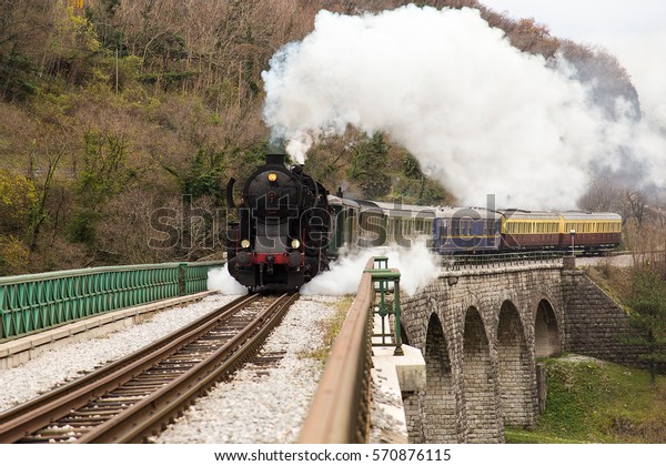Old Steam\
Train on old Stone Bridge over big\
River