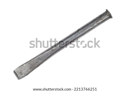 An old steel chisel on a white background. An iron chisel close-up.
