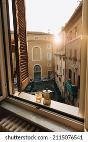 old steel Italian geyser coffee maker on a marble windowsill with a cup of hot espresso with milk. coffee prepared in a geyser coffee maker is cooled in the window. morning coffee routine in italy - Shutterstock ID 2115076541