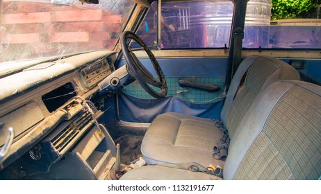 Old Steering Wheel, Stick Shift, Speedometer, Odometer And Front Seat In The Old Vintage White Steel Car.