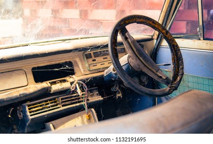 Old Steering Wheel, Stick Shift, Speedometer, Odometer And Front Seat In The Old Vintage White Steel Car.