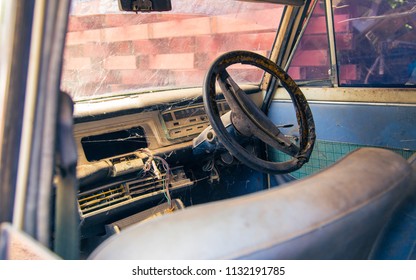 Old Steering Wheel, Stick Shift, Speedometer, Odometer And Front Seat In The Old Vintage White Steel Car.