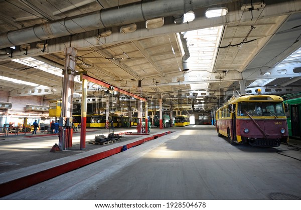 An old but\
still in use trolleybus parked on the inspection pit at the trolley\
depot. Hangar of depot\
maintenance.