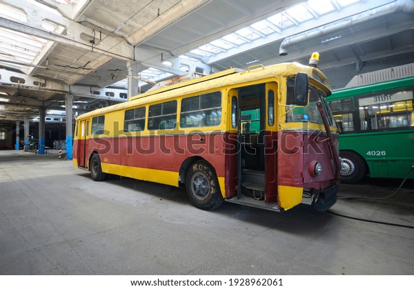 An old but still in use trolleybus parked on the\
inspection pit at the trolley depot. Hangar of depot maintenance.\
March 11, 2020. Kiev,\
Ukraine