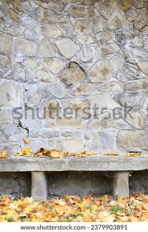 Old stone bench in autumn park. 