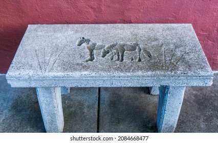 An Old Stone Bench Carved With Horses In A Quaint Small Western Town