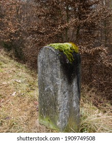 Old Stone Bollard Covered With Moss By The Road