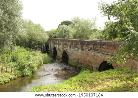 Old Stone and Brick Bridge over the River Arrow in Summertime, in Shakespeare's Country, Alcester, Warwickshire, UK.