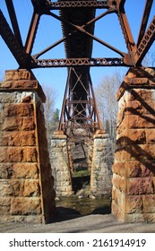 An Old Stone Bridge Holding Railroad Tracks Above. 