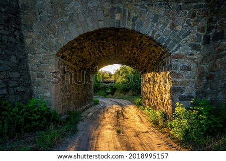 Old stone bridge and the light of the evening sun