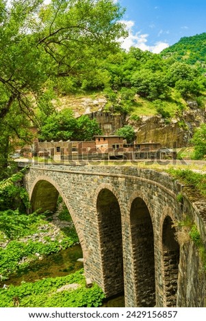 Old stone bridge under Krichim Dam wall Rhodope mountains on the river Vacha in Southern Bulgaria.July 11th 2014