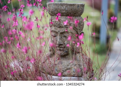 Old Stone Buddha Statue In Garden