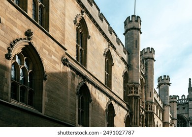 An old stone building with arched windows and turrets.  Cambridge, UK. - Powered by Shutterstock