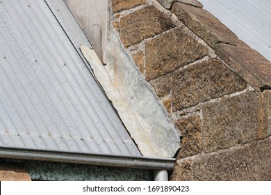 Old Stone Building With Lead Flashing Onto Metal Roof