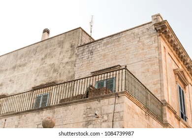 Old Stone Building With A Metal Fence