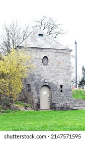 Old Stone Building Nestled In A Small Park.