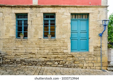 Old stone building with two windows and a door