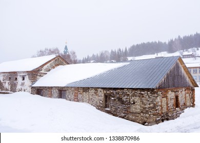 Old Stone Buildings Of 18th Century Abandoned Factory Workshops In A Rustic Winter Landscape