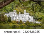 An old stone castle chateau in the forest, Kylemore Abbey with beautiful parks