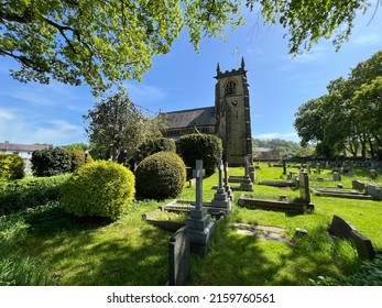 Old stone church, with trees, gravestones, and a distant forest, on a sunny day in, Sutton-in-Craven, Keighley, UK - Shutterstock ID 2159760561