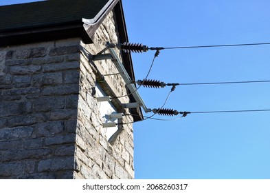 old stone electricity transformer. converts high voltage to 230 V strong commonly into the home. budpva is a stone granite tower with porcelain insulators and three cables.