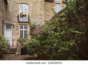 Old Stone House Exterior And Small Hidden Garden - Charming, Moody Back Yard Nook In Brittany, France.