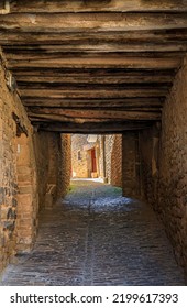 Old stone houses and narrow arched passage in a picturesque medieval village of Ujue in the Basque Country, Navarra, Spain