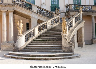 Old stone stairway of Esterhazy Castle with wrought iron banister and statues in Fertod, Hungary - Powered by Shutterstock