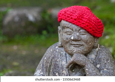 Old stone statues of Buddhist monks and nuns wearing knitted and cloth hats - Powered by Shutterstock