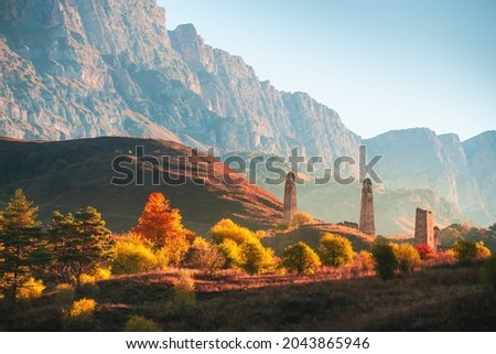 Old stone tower complex in Erzi national park in Ingushetia, Caucasus, Russia. Beautiful autumn landscape at sunrise.