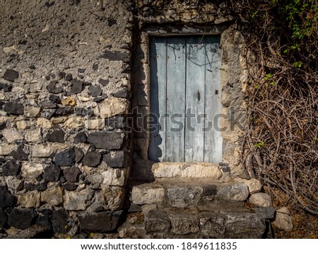 Old stone wall with  doors from medieval times, Rochemaure, France