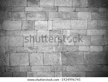 Old stone wall with vignette effect in Black and White ,vintage and antique style for background