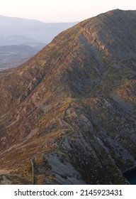 An Old Stone Wall Winding Up A Mountain In North Wales UK